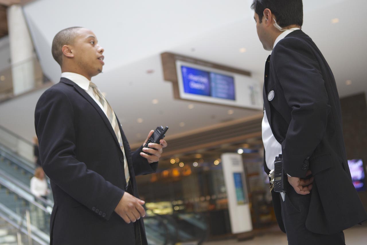 man in suit holding a walkie talkie